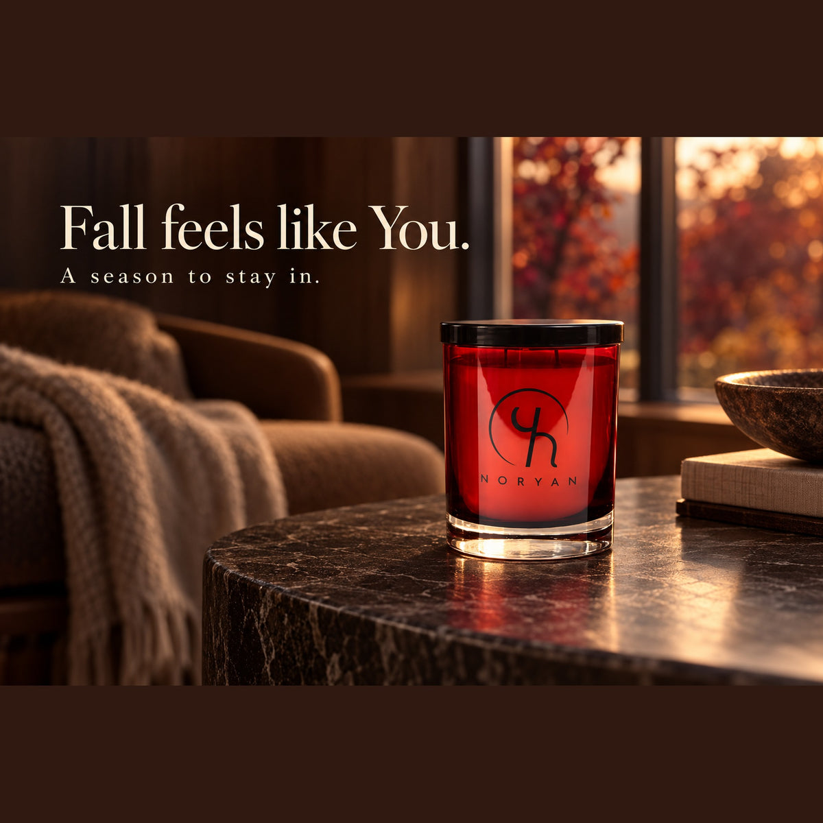 Noryan You red luxury candle in a warm autumn interior. Fall feels like You. A season to stay in.